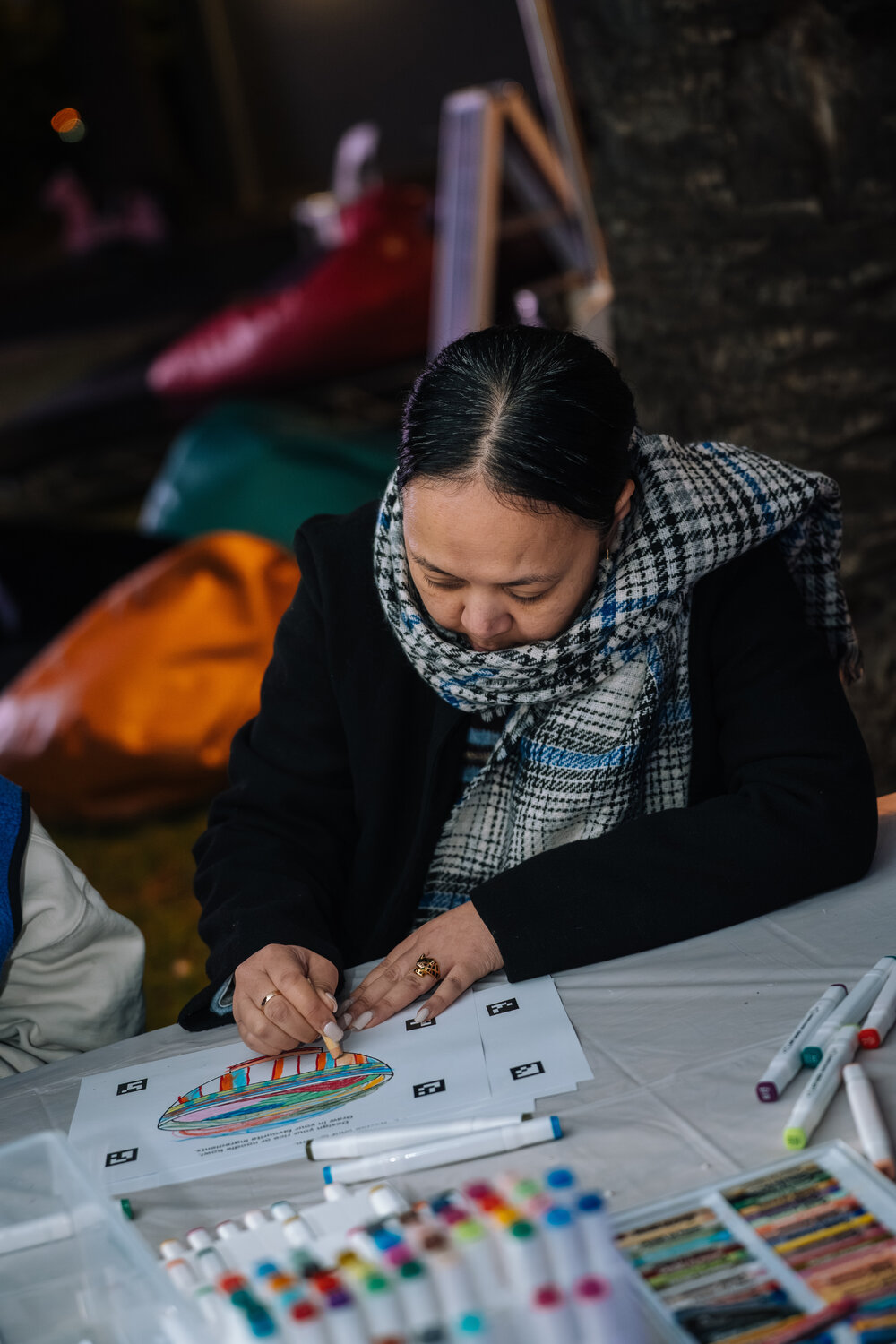 Woman colouring Eastwood Stories artwork at Ryde After Dark