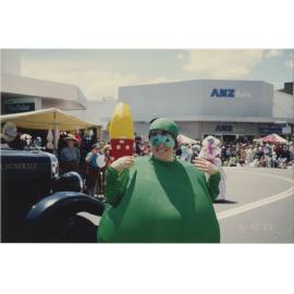 Parade particpant dressed as a Granny Smith apple