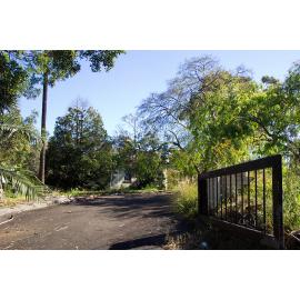 The Hermitage: view through the entrance gate towards the back of the house