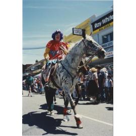 Clown riding a horse in the parade