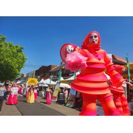 Stilt walkers in the festival parade, 2023