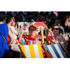 Two women taking a seat at the Lunar New Year Festival, 2024