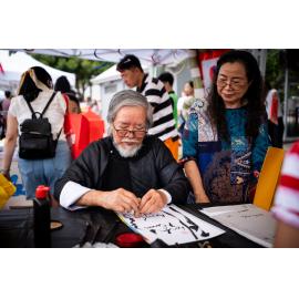 Elderly gentleman participating in calligraphy at the Lunar New Year Festival, 2025