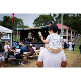 Child on adults shoulders at the Lunar New Year Festival, 2025