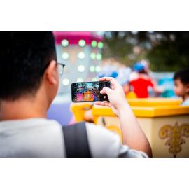 Using a smartphone to capture a moment at the Easter celebration, West Ryde
