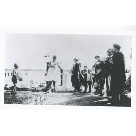 Mrs Linda Randall cutting the ribbon on opening day at the Princes Regent Swimming Club baths, Parramatta RiverRyde, 8 October 1932 