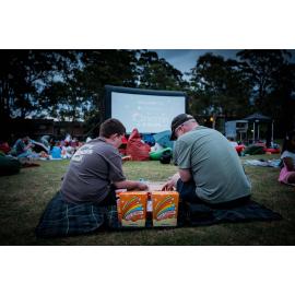 Enjoying snacks and watching a movie at Ryde's 'Cinema in the Park'