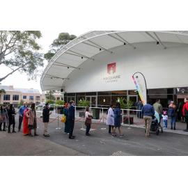 Observing social distancing whilst waiting in line for the Citizenship Ceremony, July 2022