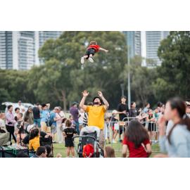 Man tossing a child into the air at the Australia Day 2026 celebrations