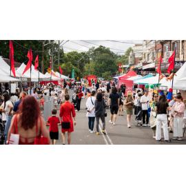 Crowds walking among food and market stalls at a Lunar New Year festival, 2026