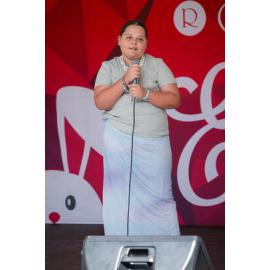 Young performer singing on stage, West Ryde Easter Celebration singing competition