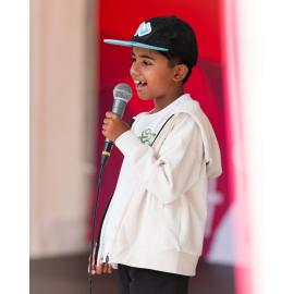 Young boy singing on stage, West Ryde Easter Celebration singing competition
