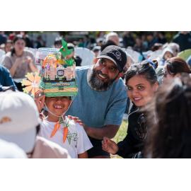 Young boy (wearing Easter hat) and his parents, West Ryde Easter Celebrations