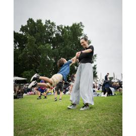 Child getting swung around at the Cork & Fork festival, Putney