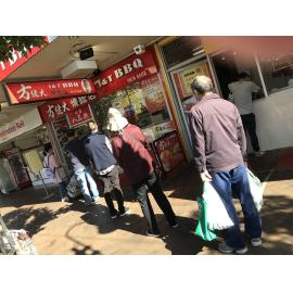 Customers practicing social distancing at J & T BBQ during the Covid pandemic, April 2020