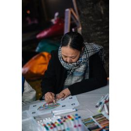 Woman colouring Eastwood Stories artwork at Ryde After Dark