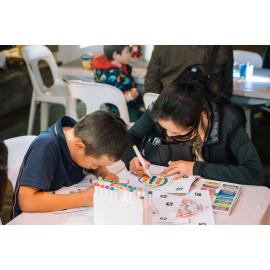 Woman and child colouring Eastwood Stories artwork at Ryde After Dark