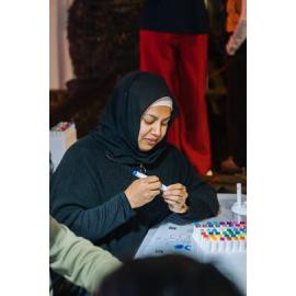 Woman colouring an Eastwood Stories artwork at Ryde After Dark