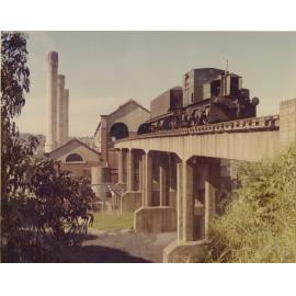 Ryde Pumping Station no.2 : 'Planet' diesel locomotive and board's coal wagon on the rail viaduct leading into the staithe inside the Boiler House, circa 1975
