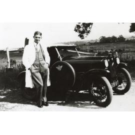 John Benson with his red Austin car at "Bensonville"
