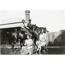 Ernest Benson and woman on horses with Val Archer on toy car and Edna Benson on rocking horse, "Comet" at Bensonville